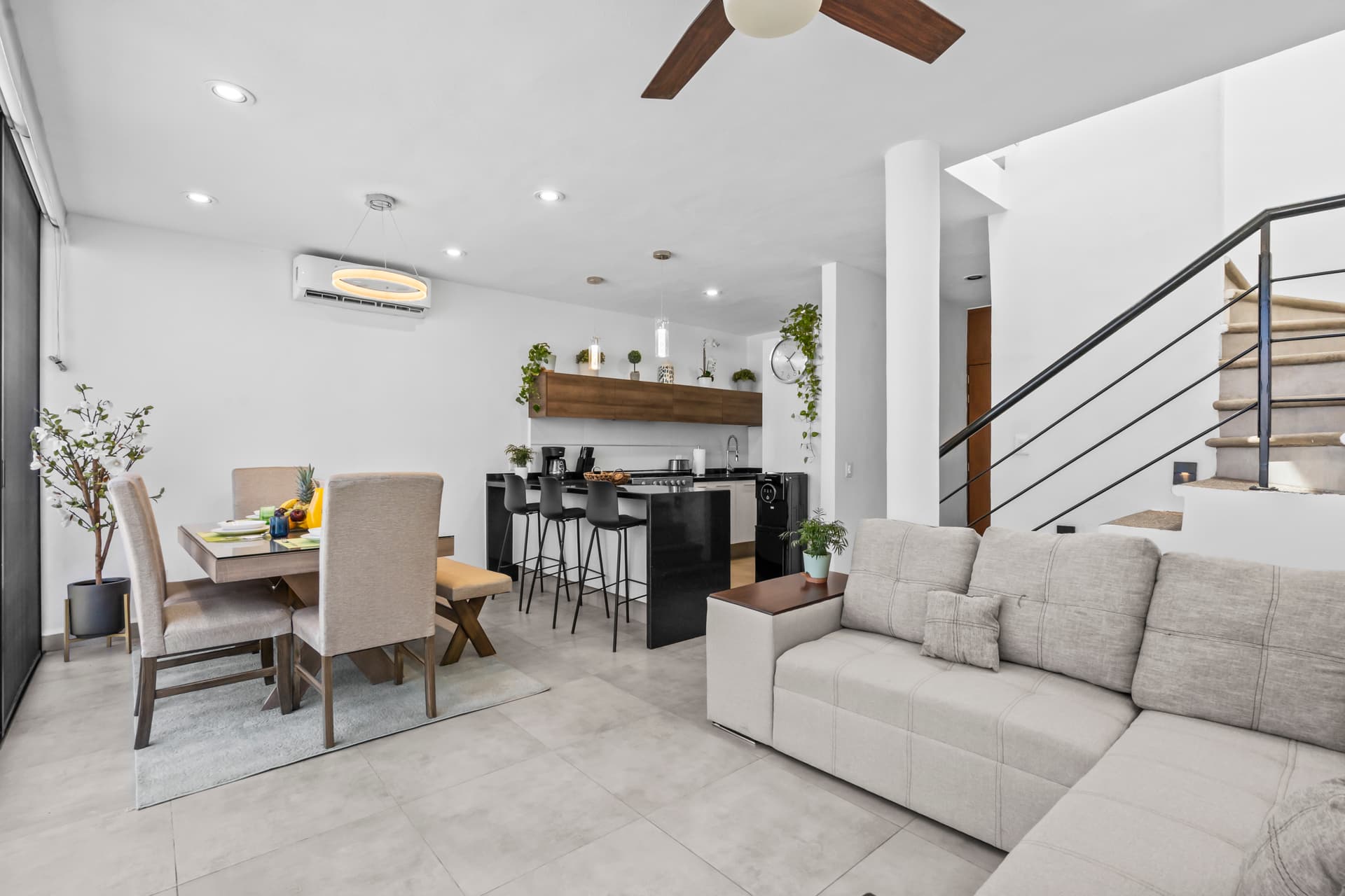 Open-plan living room, dining area, kitchen and staircase at Corales