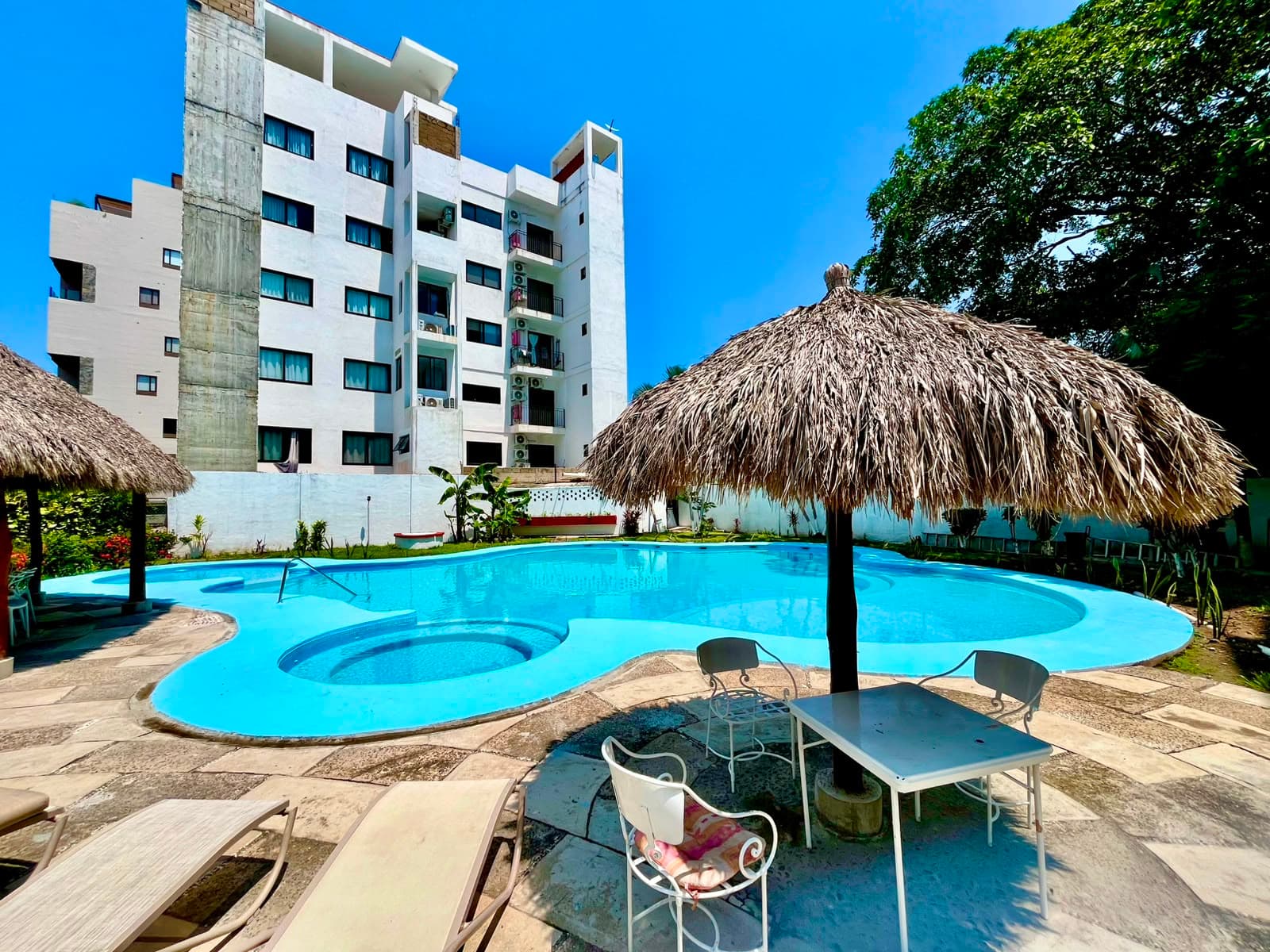 Shared pool, building, and palapa at Mangos