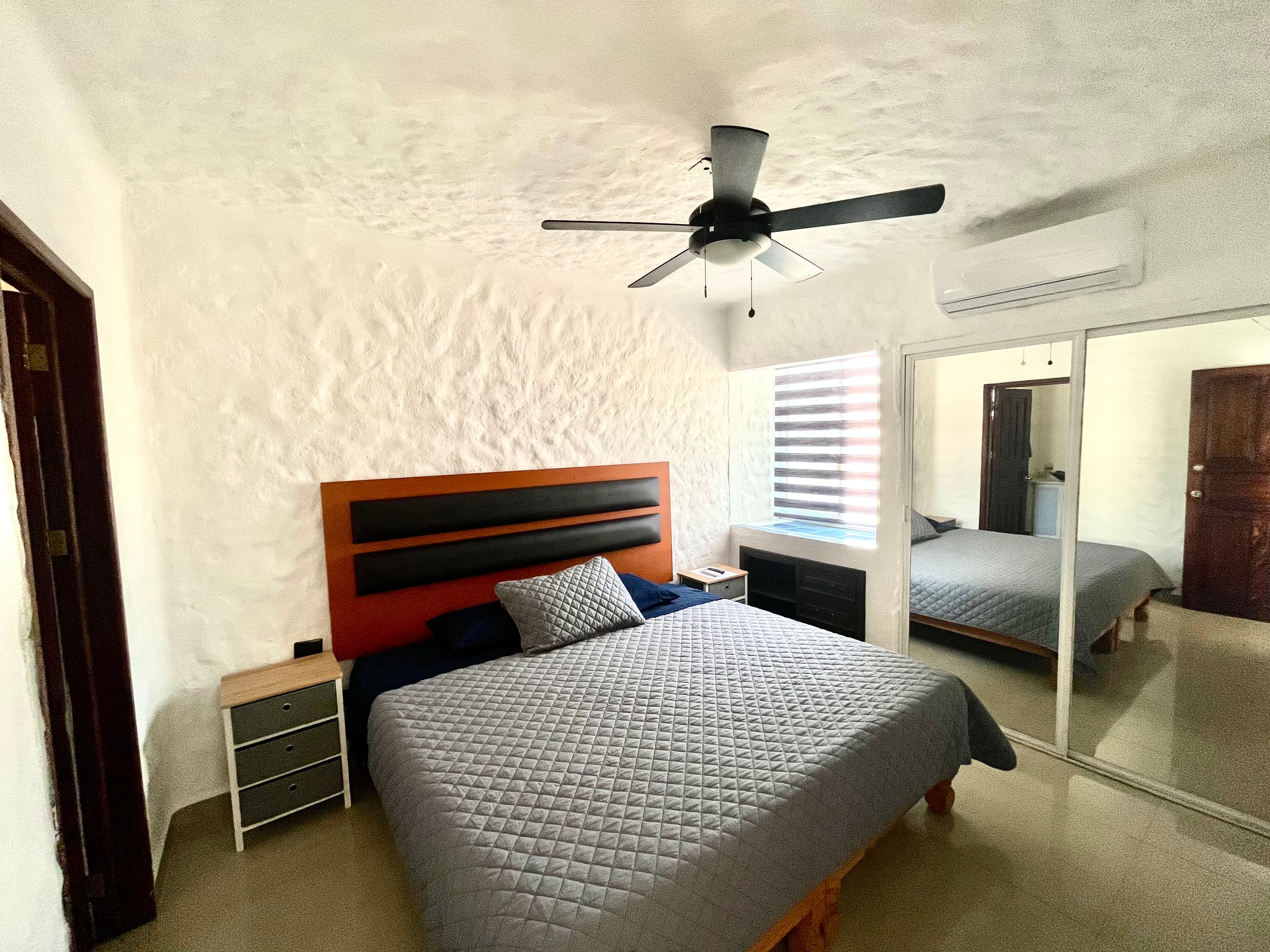Primary bedroom with King bed and en-suite bathroom at Mangos
