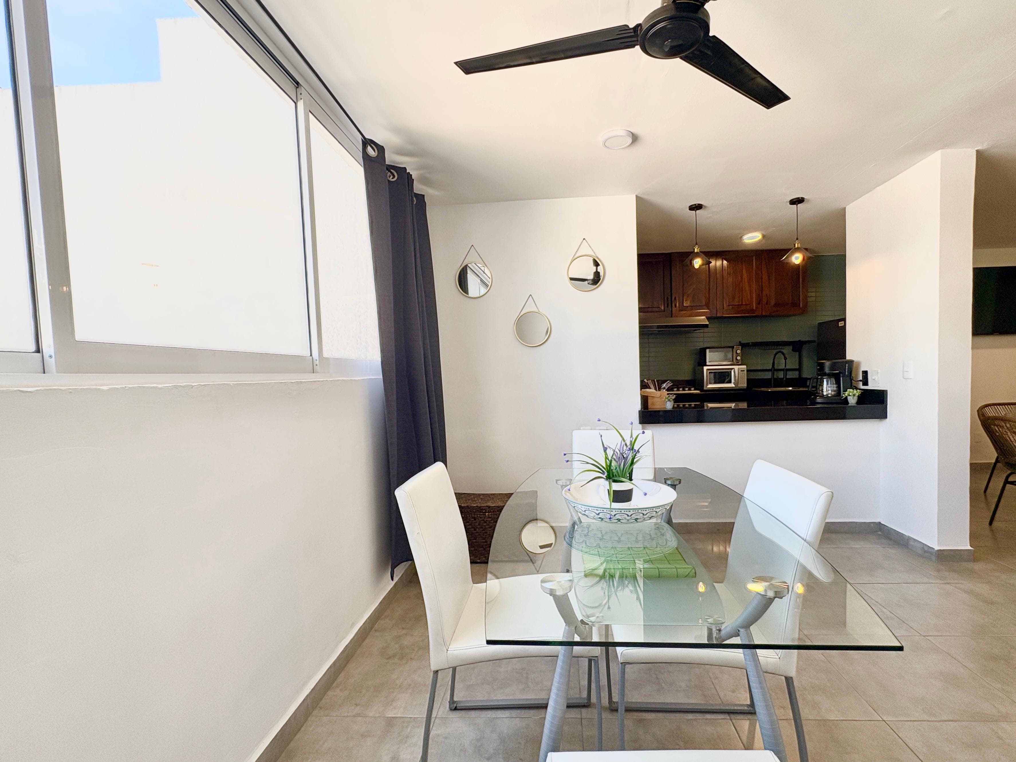 Dining area toward the kitchen with natural light at Versalles 828
