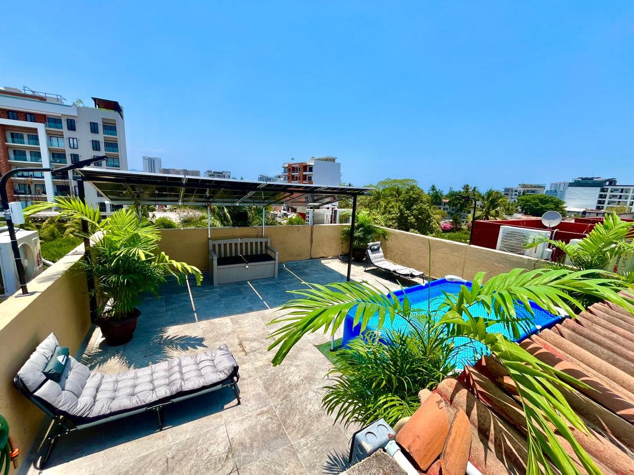 Private rooftop with plunge pool and shaded area at Versalles 837